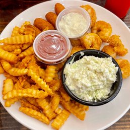 Fried shrimp with fries, hushpuppies, and slaw. Fried shrimp with fries, hushpuppies, and slaw.