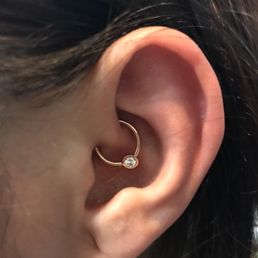 Daith piercing with solid gold seamless ring