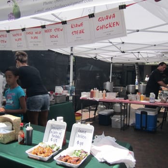 Merchant Street Market - a woman serving food to a child - Street Vendors Near Me - Honolulu, Hawaii Merchant Street Market - a woman serving food to a child - Street Vendors Near Me - Honolulu, Hawaii