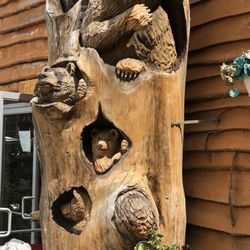 DEW Haven - Carved tree in front of Dew Haven