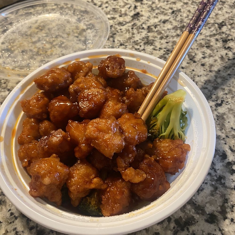 a bowl of food with chopsticks