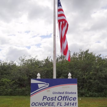 US Post Office - A patriotic picture of the post office's sign with the American flag. - Post Offices Near Me - Ochopee, Florida US Post Office - A patriotic picture of the post office's sign with the American flag. - Post Offices Near Me - Ochopee, Florida