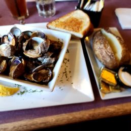 Steamed clams, garlic toast, and baked potato.