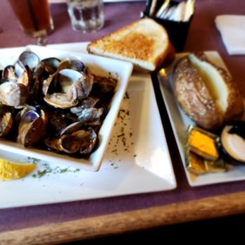 Twisted Fish Steakhouse - Steamed clams, garlic toast, and baked potato. - Steakhouses Near Me - Seaside, Oregon