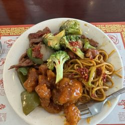 Hong Kong Buffet - Mix of General Tso's chicken, noodles, chicken with broccoli, and a bit of beef served with peppers and onions. All topped with chili oil.
