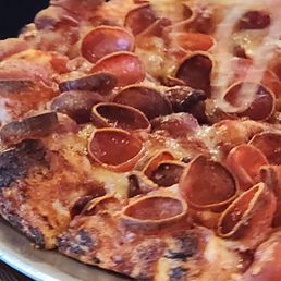 A pizza that is burnt A pizza that is burnt