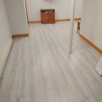 PJD Construction - a living room with a tv and wood flooring - General Contractors Near Me - Billerica, Massachusetts