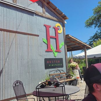 Huston Vineyards - a man sitting at a table outside - Wine Tours Near Me - Caldwell, Idaho
