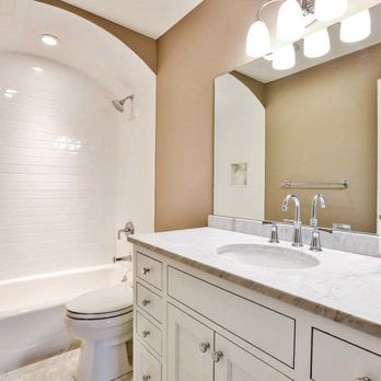 Harborview Homes - This shared bath features a custom built vanity with an arched shower stall. - General Contractors Near Me - Fairfield, Connecticut