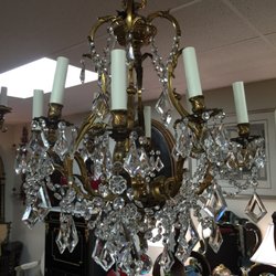 Numerous antique hanging fixtures and chandeliers of all shapes, sizes, and styles.