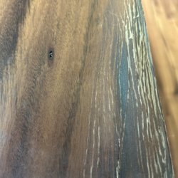 Floor & Decor - Cracking water damaged top coat thin laminate on pressed cardboard.