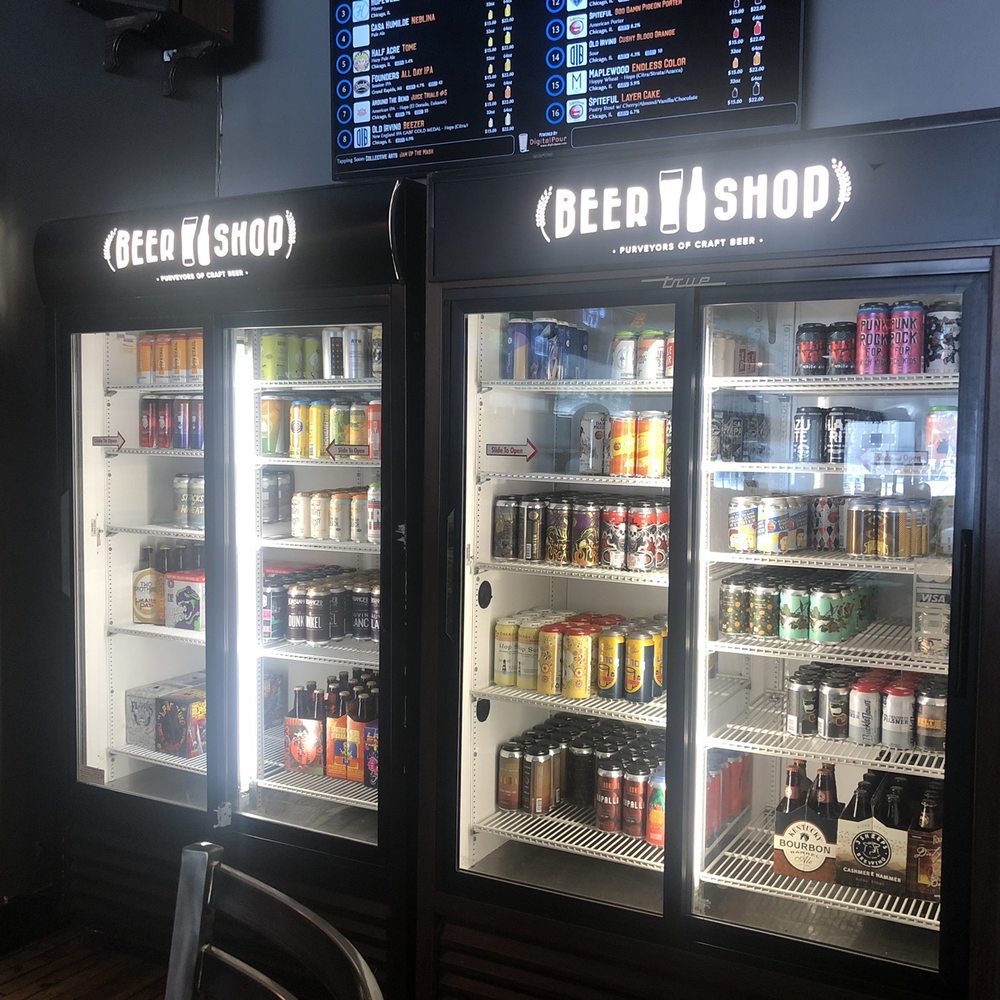 two refrigerators with beer in them