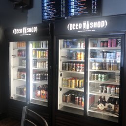 two refrigerators with beer in them