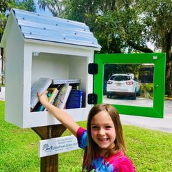 Ron Finzel's Little Free Library - My best girl dropping off some books at her favorite Library.