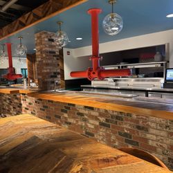 Bar area to show off Whole Foods Chefs, Sushi making, Pizza making, friends and family hangout area, leather chairs, etc.