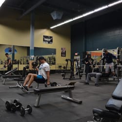 Richmond Sports and Fitness - Weight Room with lots of dumbells, benches, bench presses and fixed barbells