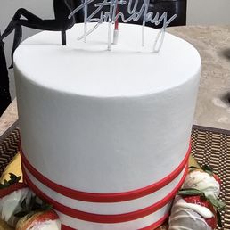 the silhouette of a woman sitting on top of a cake