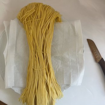 Pasta Plus - a piece of paper and a knife on a table - Beer, Wine & Spirits Near Me - Eugene, Oregon
