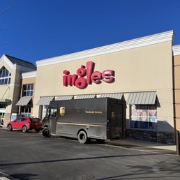 a delivery truck parked in front of a store a delivery truck parked in front of a store