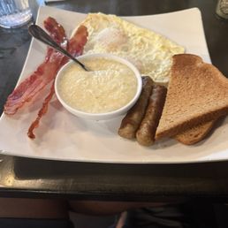 Eggs over medium (actually over easy) Bacon and sausage  Best grits ever! Toast