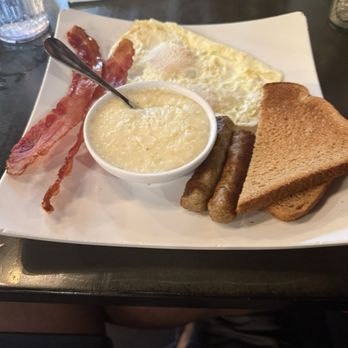 Sunrise City Cafe - Eggs over medium (actually over easy) Bacon and sausage  Best grits ever! Toast - Breakfast & Brunch Near Me - Fort Pierce, Florida