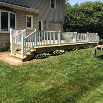 Dutchmen Construction - a deck with railings - Roofing Near Me - Orangeburg, New York Dutchmen Construction - a deck with railings - Roofing Near Me - Orangeburg, New York