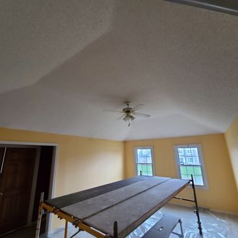 Michael's Interior Services - a room with a ceiling fan - Drywall Installation & Repair Near Me