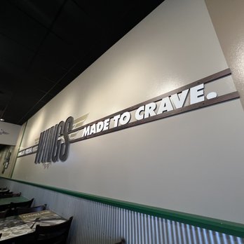 Wingstop - inside of a restaurant with tables and chairs - Chicken Wings Near Me - Clinton, Maryland