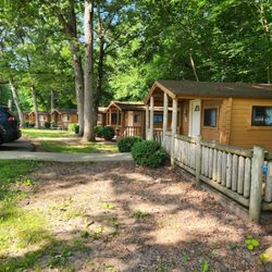 Sun Retreats Millbrook by Sun Communities - Rustic two room cabins. Cabin 26 is closest to the camera with an extended deck.
