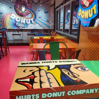 Hurts Donut - Inside Hurts Donut, the decor features bright colors, pop art murals, and playful furniture, including a table with a comic-style design. - Donuts Near Me - Cincinnati, Ohio