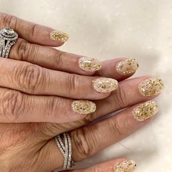 Dipped gold flake powder over one layer of pearl glitter powder. Natural nail with slight coffin shape. Nail Technician: Angel