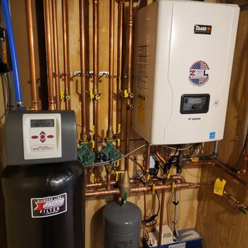 ZSL Plumbing - Laars high efficiency wall hung combination boiler water heater and whole house water filter pictured here in this mechanical room by ZSL - Plumbing Near Me - Ronkonkoma, New York ZSL Plumbing - Laars high efficiency wall hung combination boiler water heater and whole house water filter pictured here in this mechanical room by ZSL - Plumbing Near Me - Ronkonkoma, New York