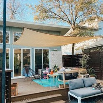 Kb Contractors TX - a patio with a couch, table, and umbrella - General Contractors Near Me Kb Contractors TX - a patio with a couch, table, and umbrella - General Contractors Near Me