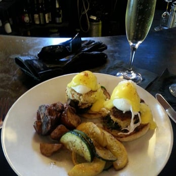Maxine's On Shine - Eggs Benedict Florentine over super-crabby Crab Cakes. Taters roasted in kosher salt and oil, and California sparkling Brut. - New American Near Me - Orlando, Florida Maxine's On Shine - Eggs Benedict Florentine over super-crabby Crab Cakes. Taters roasted in kosher salt and oil, and California sparkling Brut. - New American Near Me - Orlando, Florida