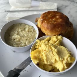 Honey Butter Chicken biscuit with grits and eggs. Honey Butter Chicken biscuit with grits and eggs.