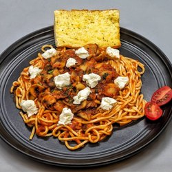 Buono Mangia - Our scratch-made tagliolini with mushrooms in marinara and topped with goat cheese. Served with garlic toast. At BuonoMangia.