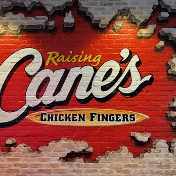 Raising Cane's Chicken Fingers - a brick wall with a hole in it - Fast Food Near Me - Chicago, Illinois