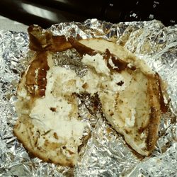 Commons café - Rock hard toasted everything bagel with a smear of cream cheese and two skinny strips of bacon.