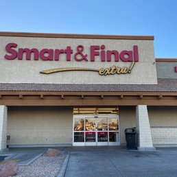 a woman standing in front of a smart & final extra store