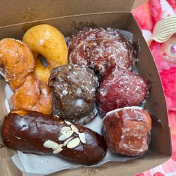 Glazed donut $1.45 | donut twist $1.55 | chocolate covered long John $2.12 | poi/strawberry/orange malasadas $1.55/ea| banana fritter $1.55