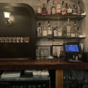 June - a bar with liquor bottles on shelves - Wine Bars Near Me - Brooklyn, New York