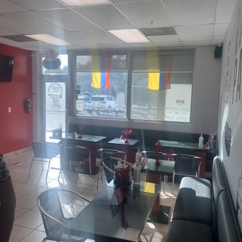 Pao Pao Fast Food - a woman sitting at a table - Colombian Near Me - Miami, Florida