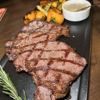 Epique Restaurant - a steak on a black plate with a side of vegetables - Armenian Near Me - Glendale, California