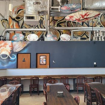 Texas Sake - The koi graffiti travels up the wall into a large group of fish near the ceiling. - Breweries Near Me - Austin, Texas Texas Sake - The koi graffiti travels up the wall into a large group of fish near the ceiling. - Breweries Near Me - Austin, Texas