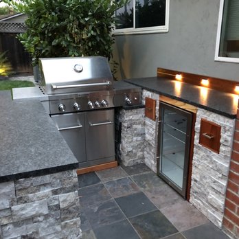 Jones Masonry - outdoor kitchen with stainless steel appliances - General Contractors Near Me