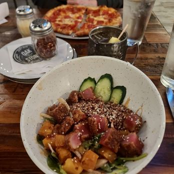 Oak & Stone - Foreground: poke bowl and pineapple mule Background: pepperoni pizza - Breakfast & Brunch Near Me - Estero, Florida