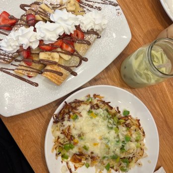 Broken Yolk Cafe - Nutella Crepe. Hash browns w/ jack cheese, poblano sauce, green bell pepper and onion. Matcha tea latte w/ oat milk & a shot of hazelnut. - Breakfast & Brunch Near Me - Henderson, Nevada