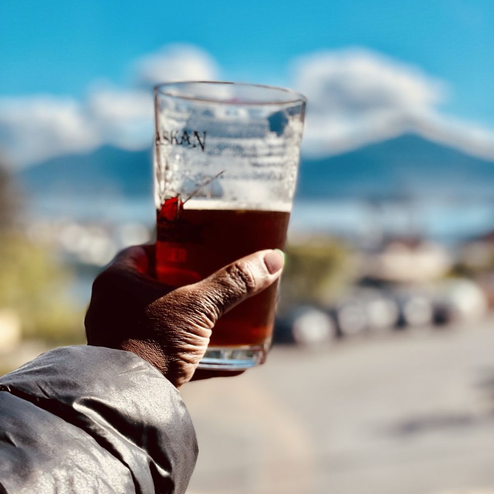 Bayview Pub - a hand holding a pint of beer - New American Near Me - Sitka, Alaska Bayview Pub - a hand holding a pint of beer - New American Near Me - Sitka, Alaska