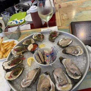 Anna Maria Oyster Bar - Raw oysters, oysters chimichurri, gluten-free French fries, and a delightful Sauvignon Blank. - Seafood Near Me - Bradenton, Florida Anna Maria Oyster Bar - Raw oysters, oysters chimichurri, gluten-free French fries, and a delightful Sauvignon Blank. - Seafood Near Me - Bradenton, Florida