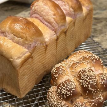 Crust & Crumb Bread Alchemy - a loaf of bread on a cooling rack - Desserts Near Me